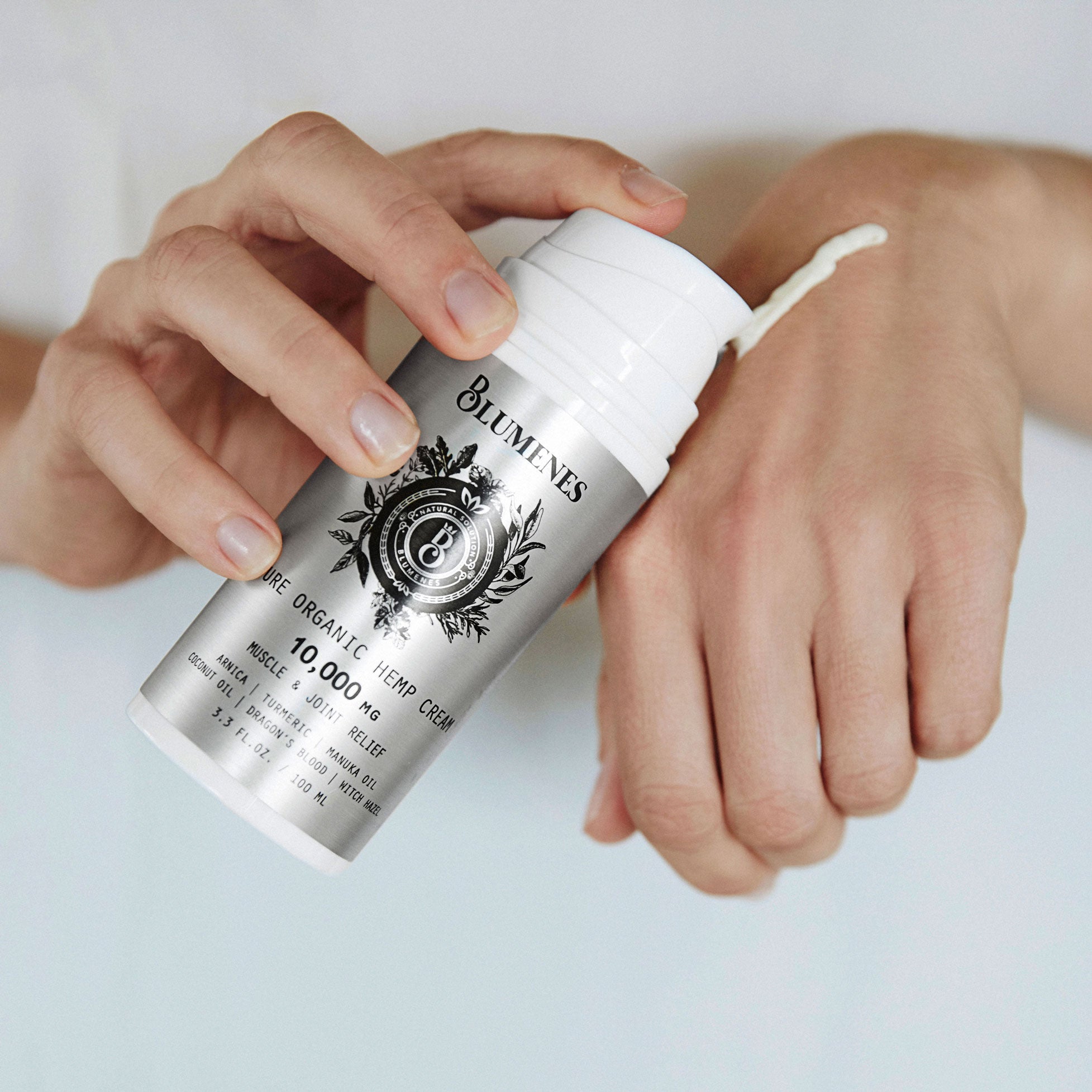 Woman using a natural, organic, plant-based product with Hemp and organic ingredients on her hand to relieve tension, inflammation, pain, and arthritis.