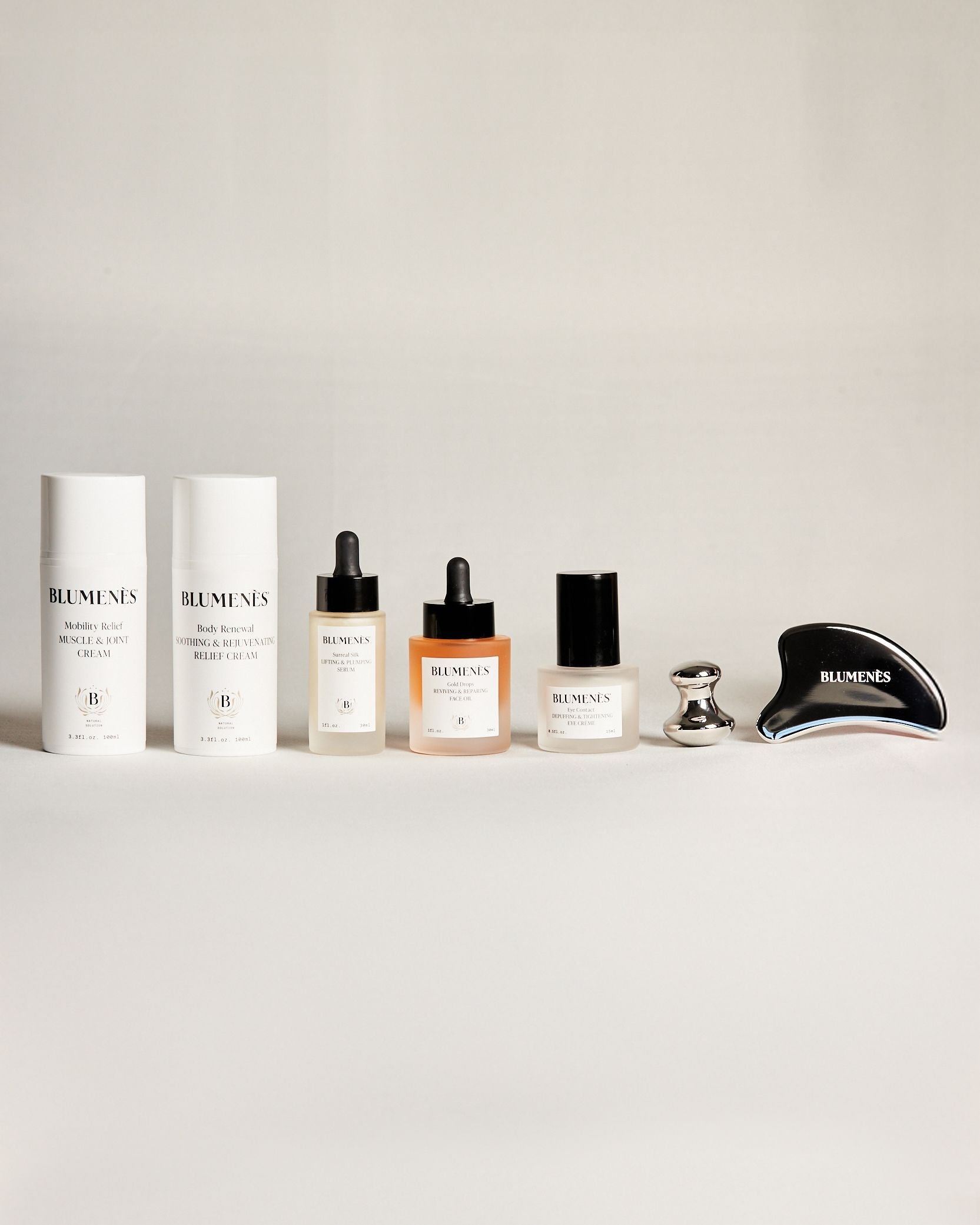 Blumenès skincare products on marble surface — skin education